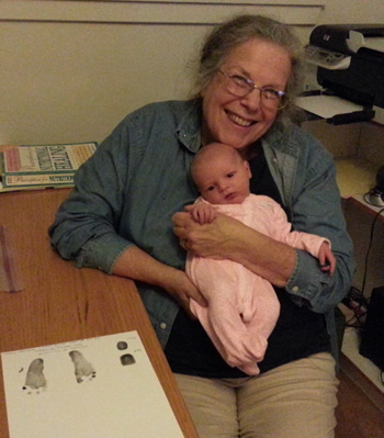 Midwife Karen Ehrlich making footprints for a newborn baby.